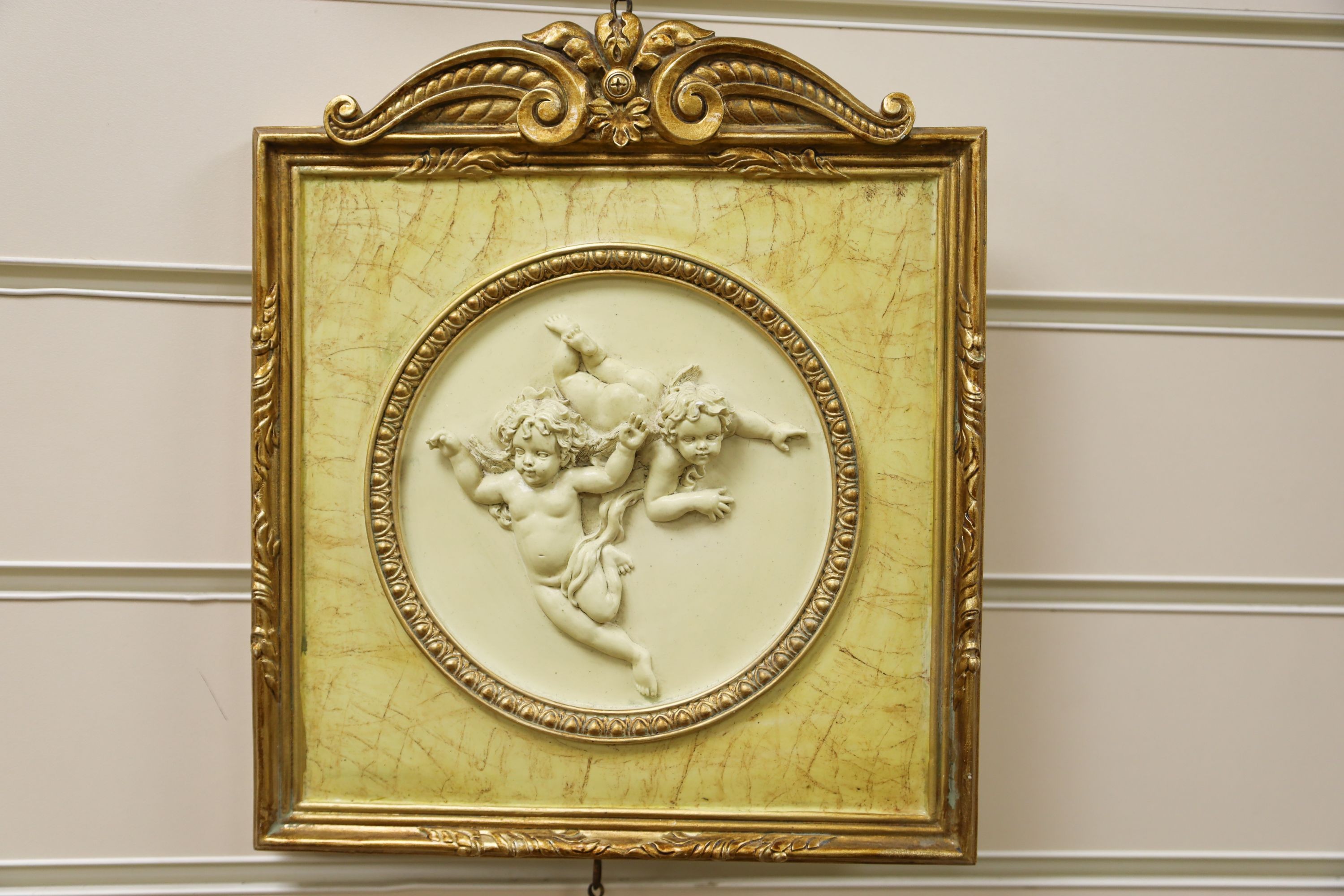 A set of three gilt framed composition plaques 27x23cm